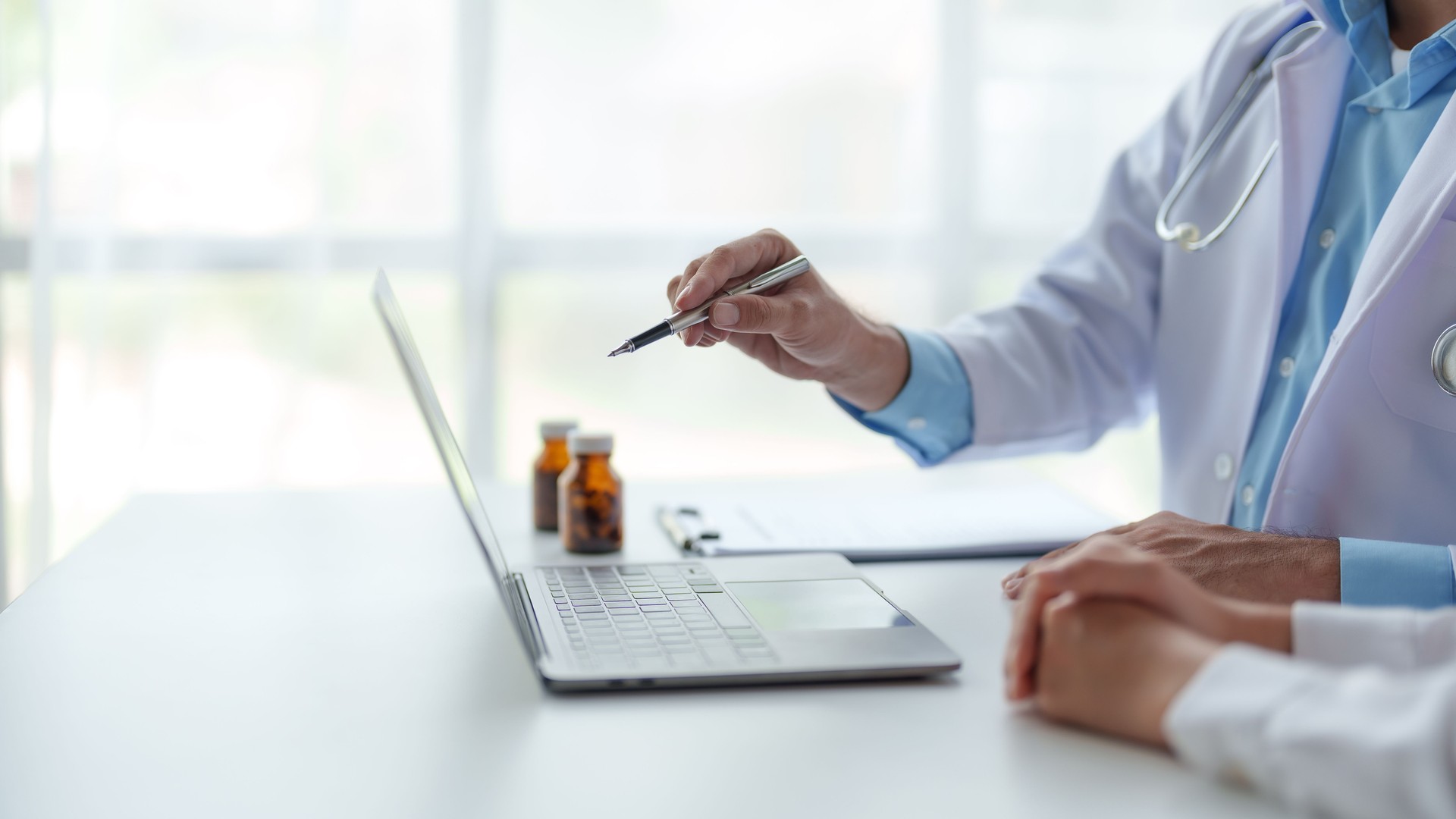 Doctor are explaining patient treatment and medication information. Patient self-care through laptop computer.